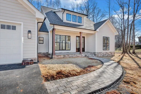 a view of a house with tub couches and wooden fence