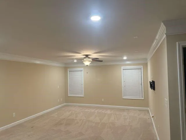 an empty room with fan and entrance
