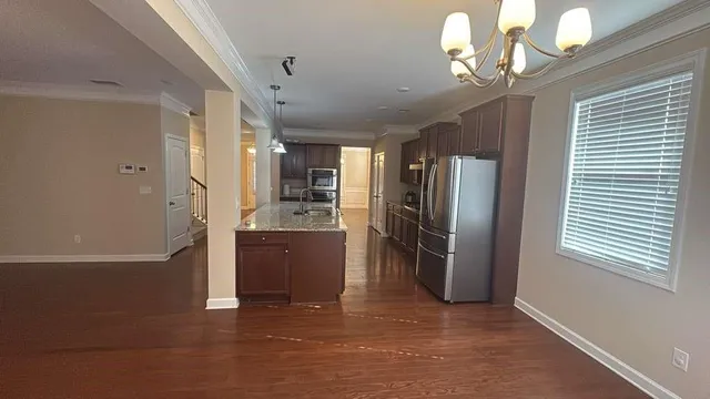 a view of a kitchen with a refrigerator and microwave