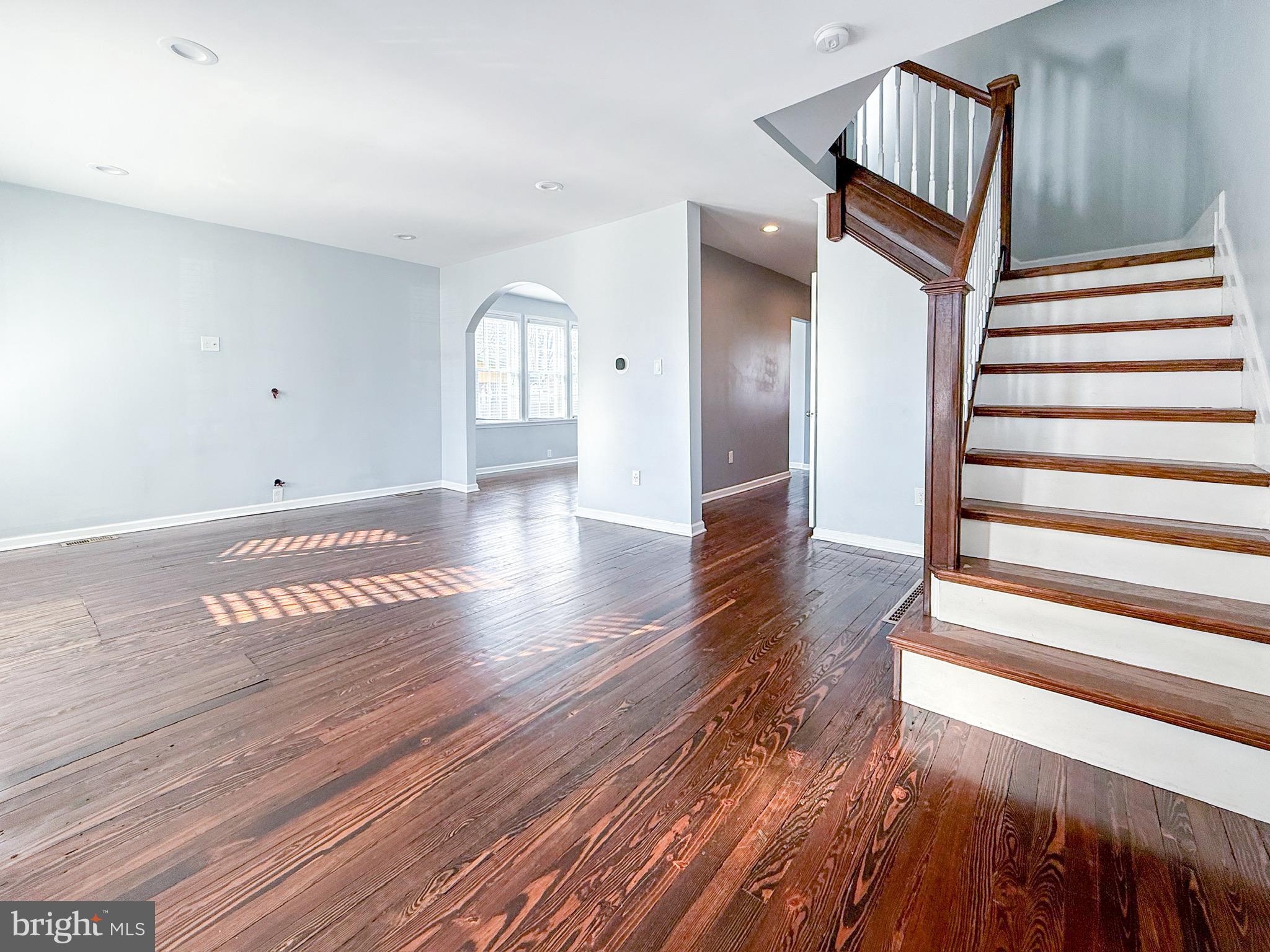 209 West Madison Avenue Magnolia, NJ 08049 - Photo 3 of 11 a view of a hallway with wooden floor and stairs