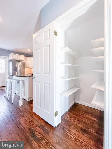 a view of a kitchen with wooden floor and a kitchen
