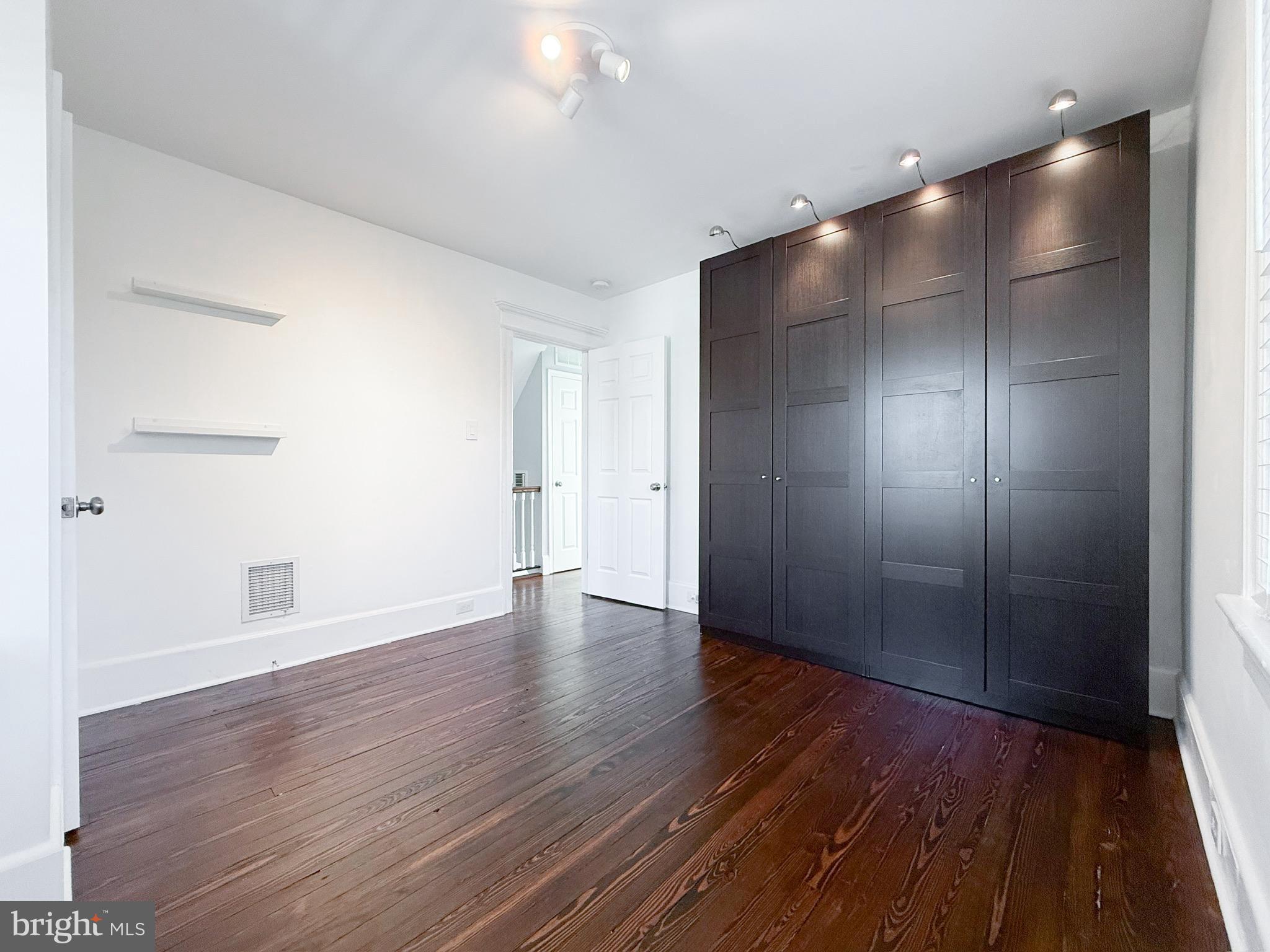 209 West Madison Avenue Magnolia, NJ 08049 - Photo 6 of 11 a view of an empty room with wooden floor