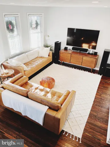 a bedroom with furniture and a flat screen tv