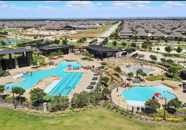 an aerial view of a house with a swimming pool yard and outdoor seating