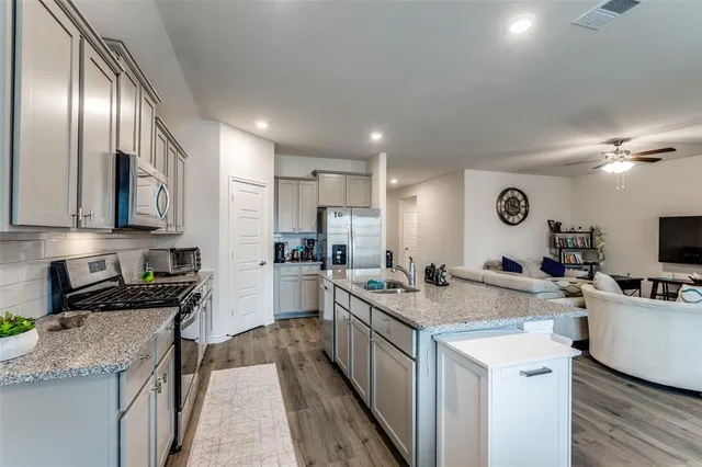 a kitchen with a sink stove and cabinets
