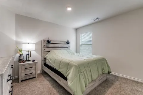 a bedroom with a bed and a cabinets