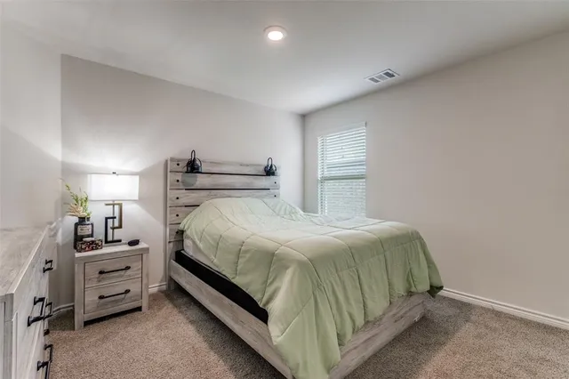 a bedroom with a bed and a cabinets