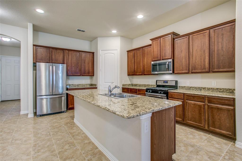 1608 Saddle Ridge Road Wylie, TX 75098 - Photo 1 of 1 a kitchen with a refrigerator sink and microwave