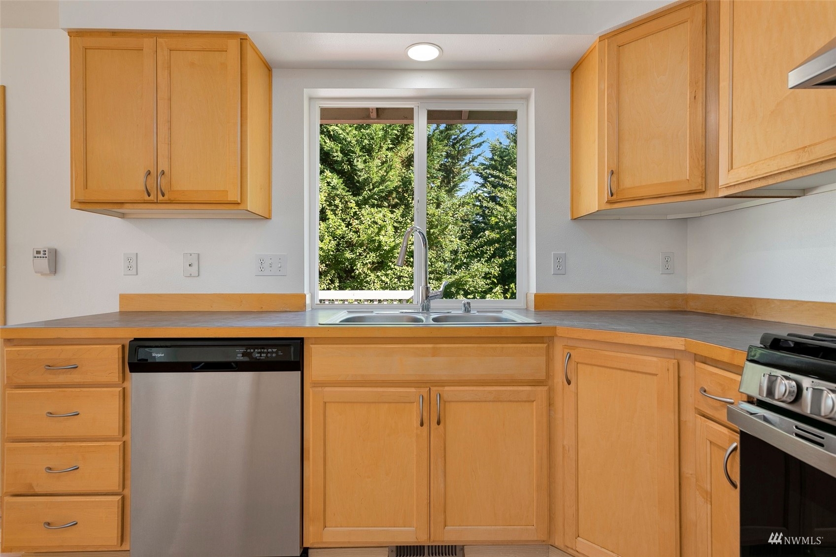 714 Northwest 3rd Court Renton, WA 98057 - Photo 20 of 40 a kitchen with granite countertop white cabinets and black appliances