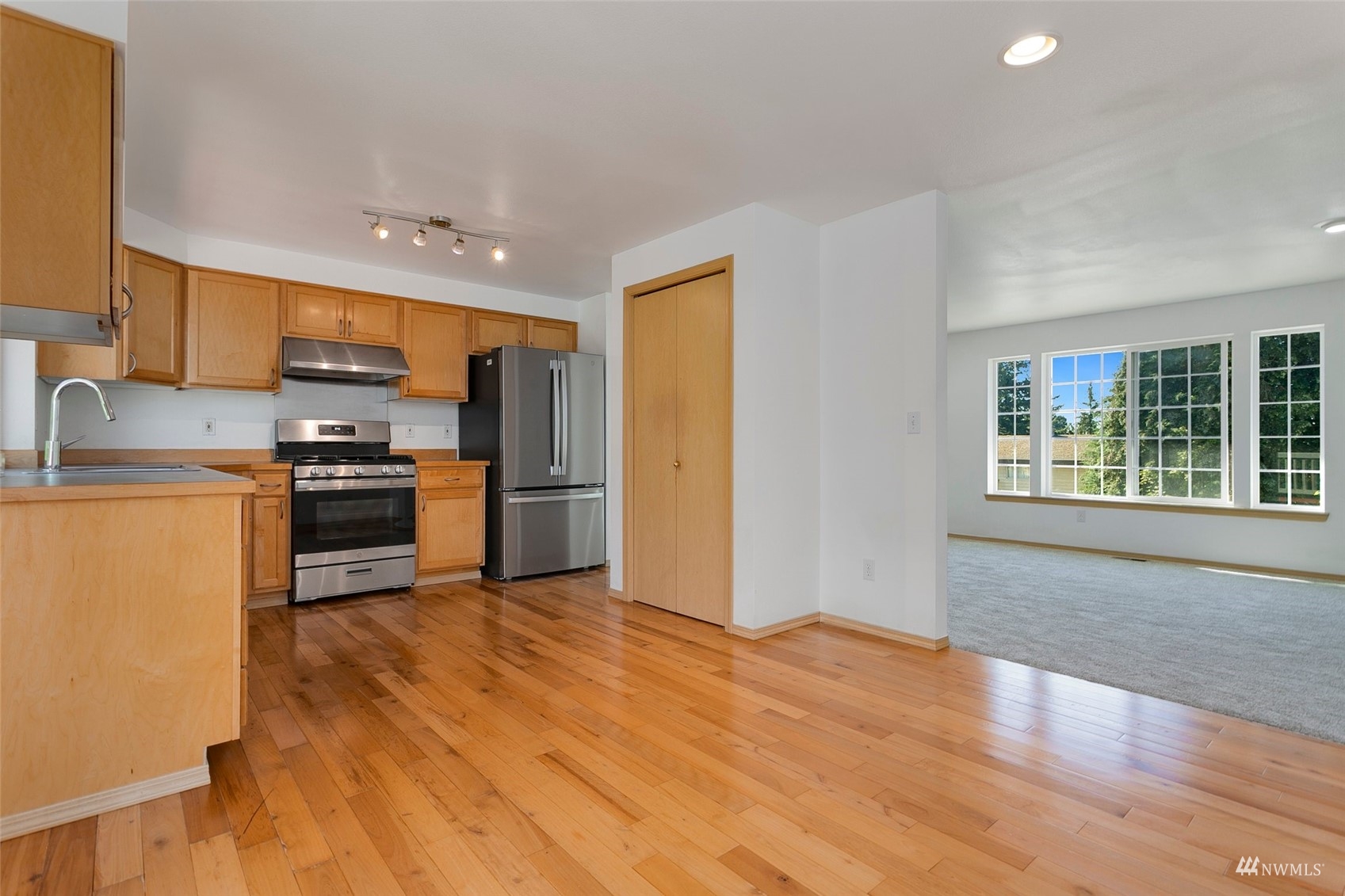 714 Northwest 3rd Court Renton, WA 98057 - Photo 21 of 40 a kitchen with granite countertop a refrigerator and a stove top oven