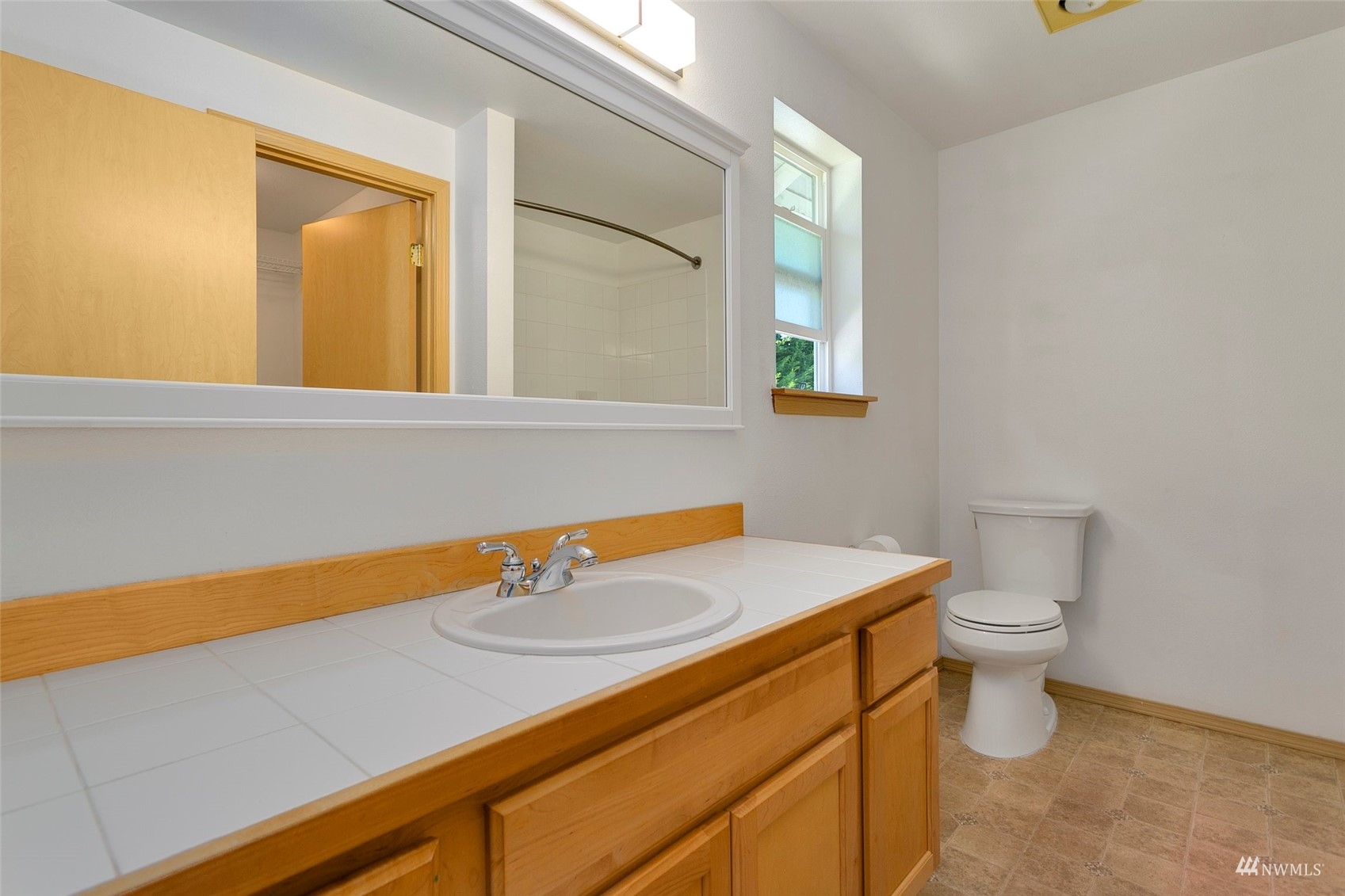 714 Northwest 3rd Court Renton, WA 98057 - Photo 25 of 40 a bathroom with a sink a toilet and a window
