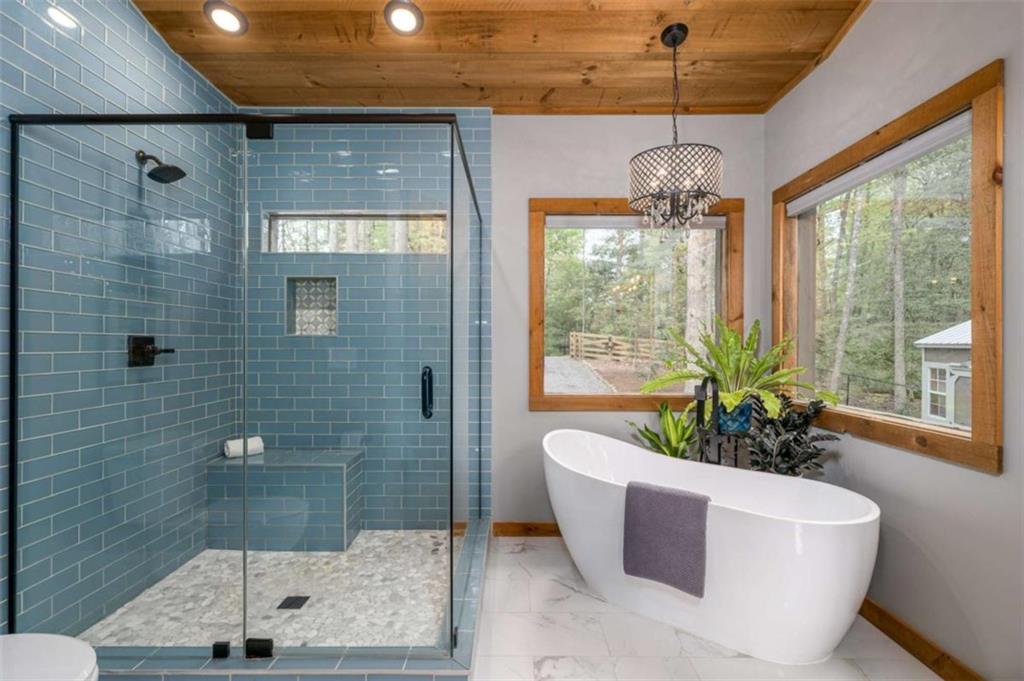 454 North Old Aska Road Blue Ridge, GA 30513 - Photo 17 of 33 a bath room with a window and a chandelier