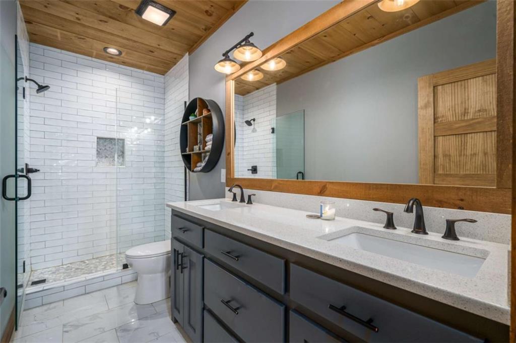 454 North Old Aska Road Blue Ridge, GA 30513 - Photo 23 of 33 a bathroom with a double vanity sink mirror and toilet
