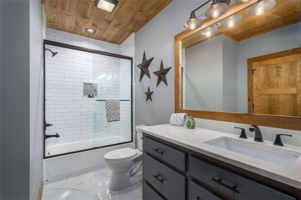 454 North Old Aska Road Blue Ridge, GA 30513 - Photo 24 of 33 a bathroom with a granite countertop sink toilet and shower