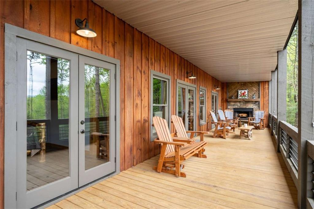 454 North Old Aska Road Blue Ridge, GA 30513 - Photo 28 of 33 a view of a patio with table and chairs floor to ceiling window with wooden floor