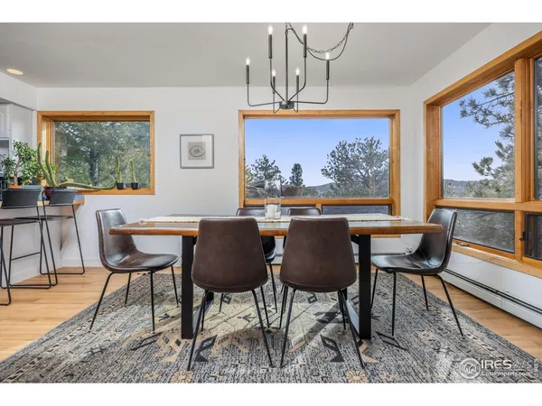 a dining room with furniture a rug and a painting