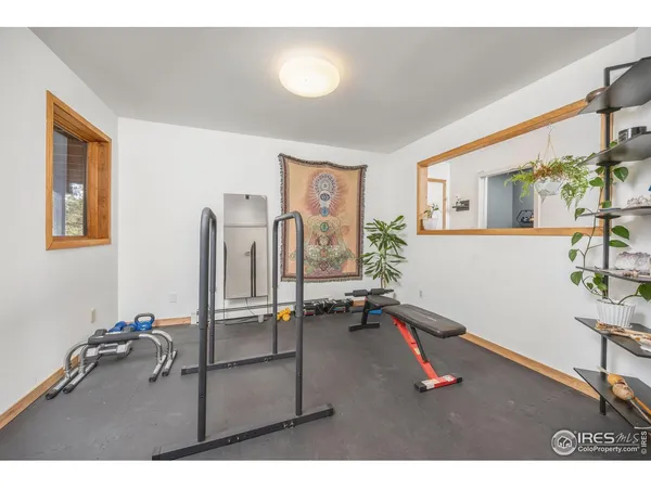 a room with gym equipment and a table