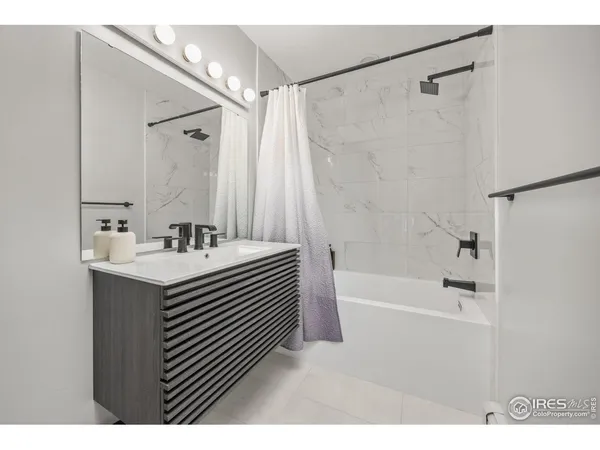 a bathroom with a sink a mirror and a shower