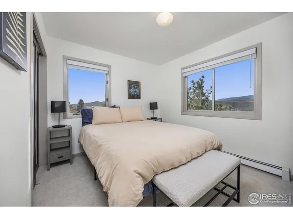 a bedroom with a bed and a painting on the wall