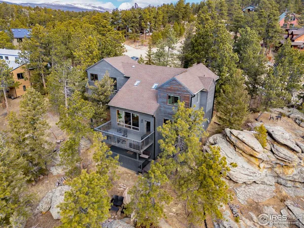 an aerial view of a house with a yard
