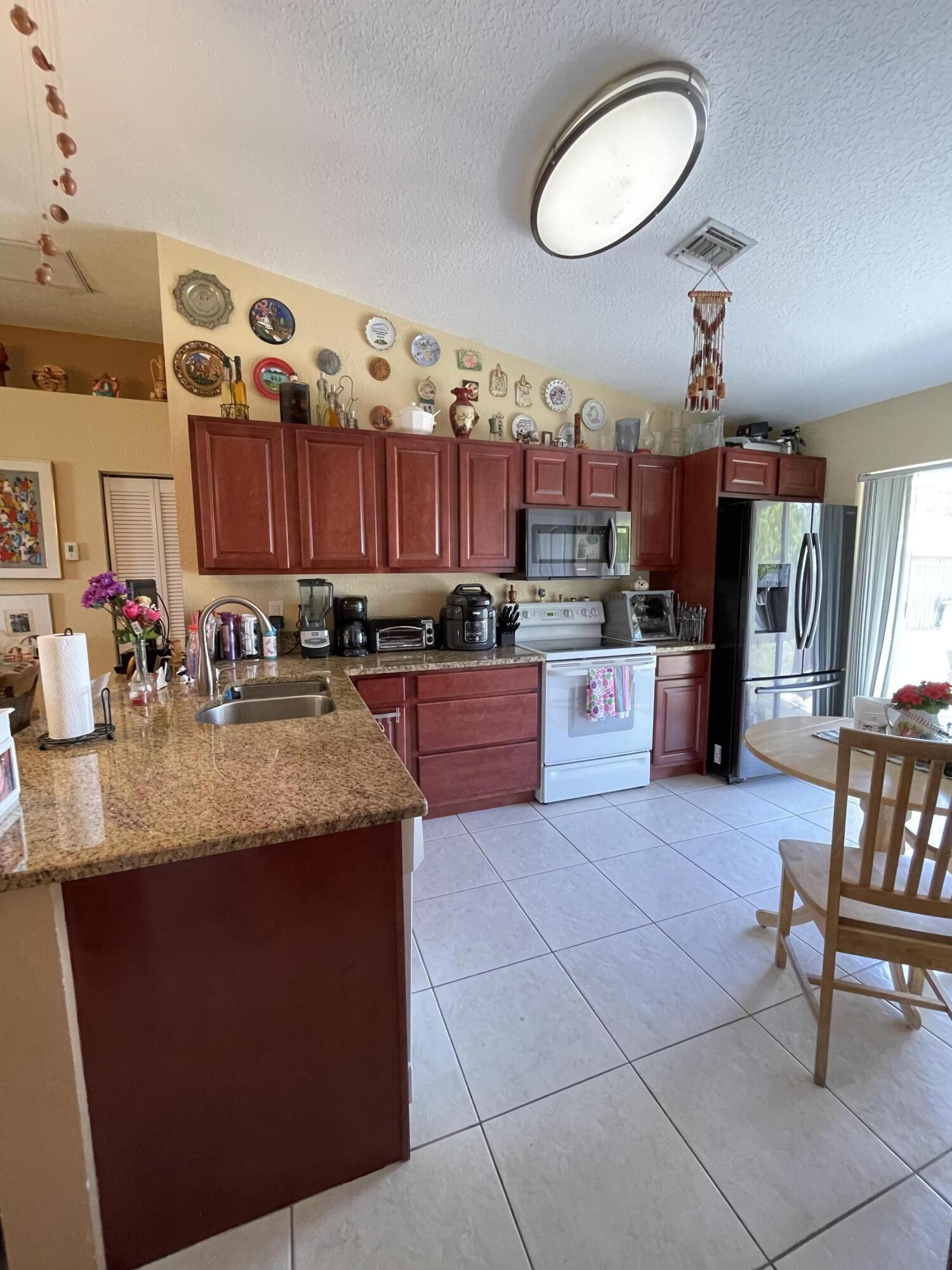 4369 Dale Road Palm Springs, FL 33406 - Photo 11 of 14 LOTS OF KITCHEN CABINETS