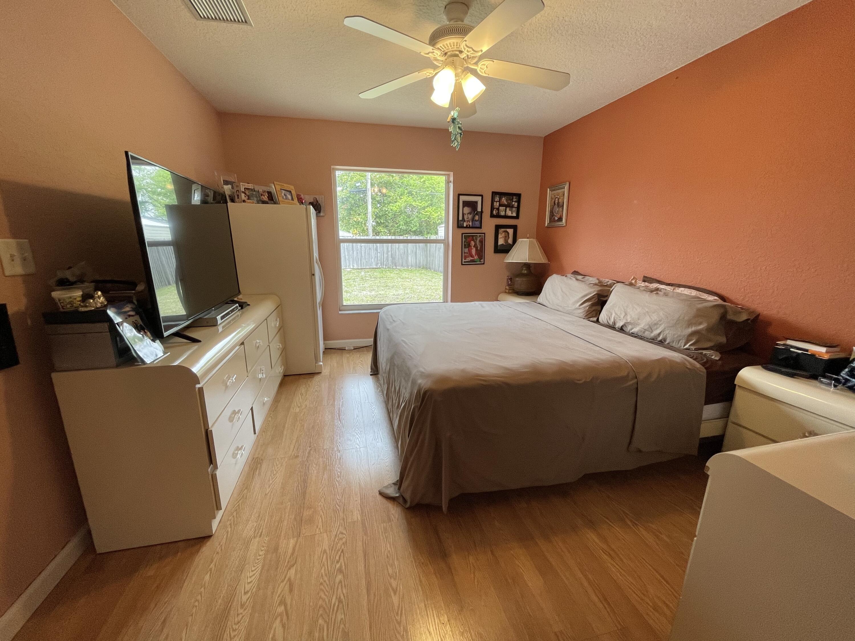 4369 Dale Road Palm Springs, FL 33406 - Photo 5 of 14 MASTER BEDROOM WITH ENSUITE BATHROOM