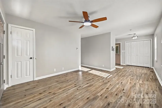 a view of an empty room and wooden floor