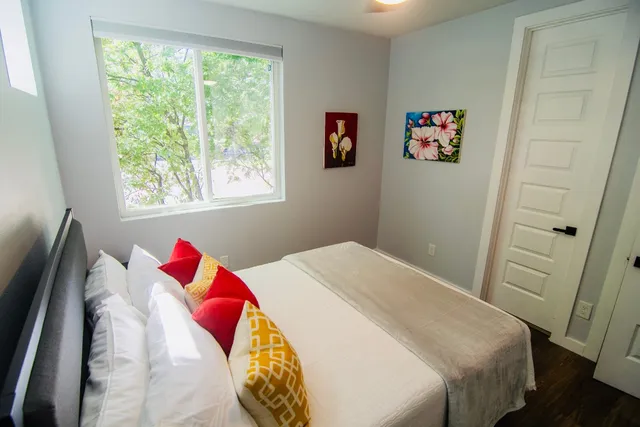 a bed with a bed and a painting on the wall