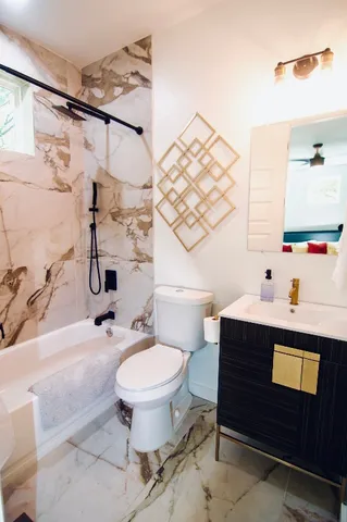 a bathroom with a sink toilet and shower