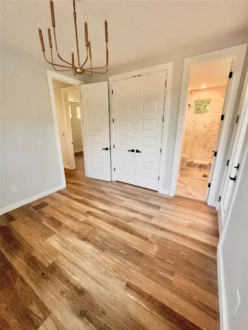 a view of a room with wooden floor