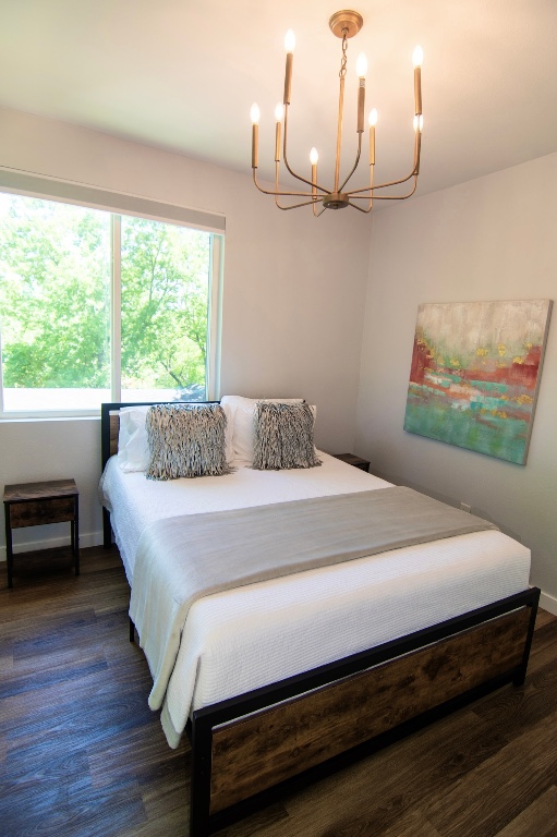 3508 Robinson Avenue, Unit B Austin, TX 78722 - Photo 7 of 17 a bedroom with a bed wooden floor and window