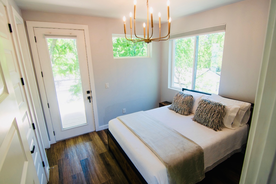 3508 Robinson Avenue, Unit B Austin, TX 78722 - Photo 8 of 17 a bedroom with a bed and a large window