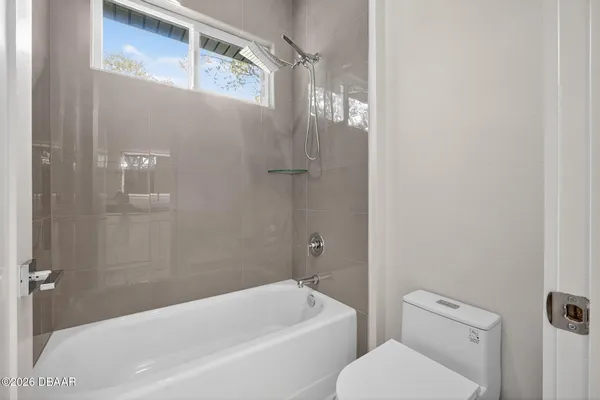 a view of a bathroom with a shower and a sink