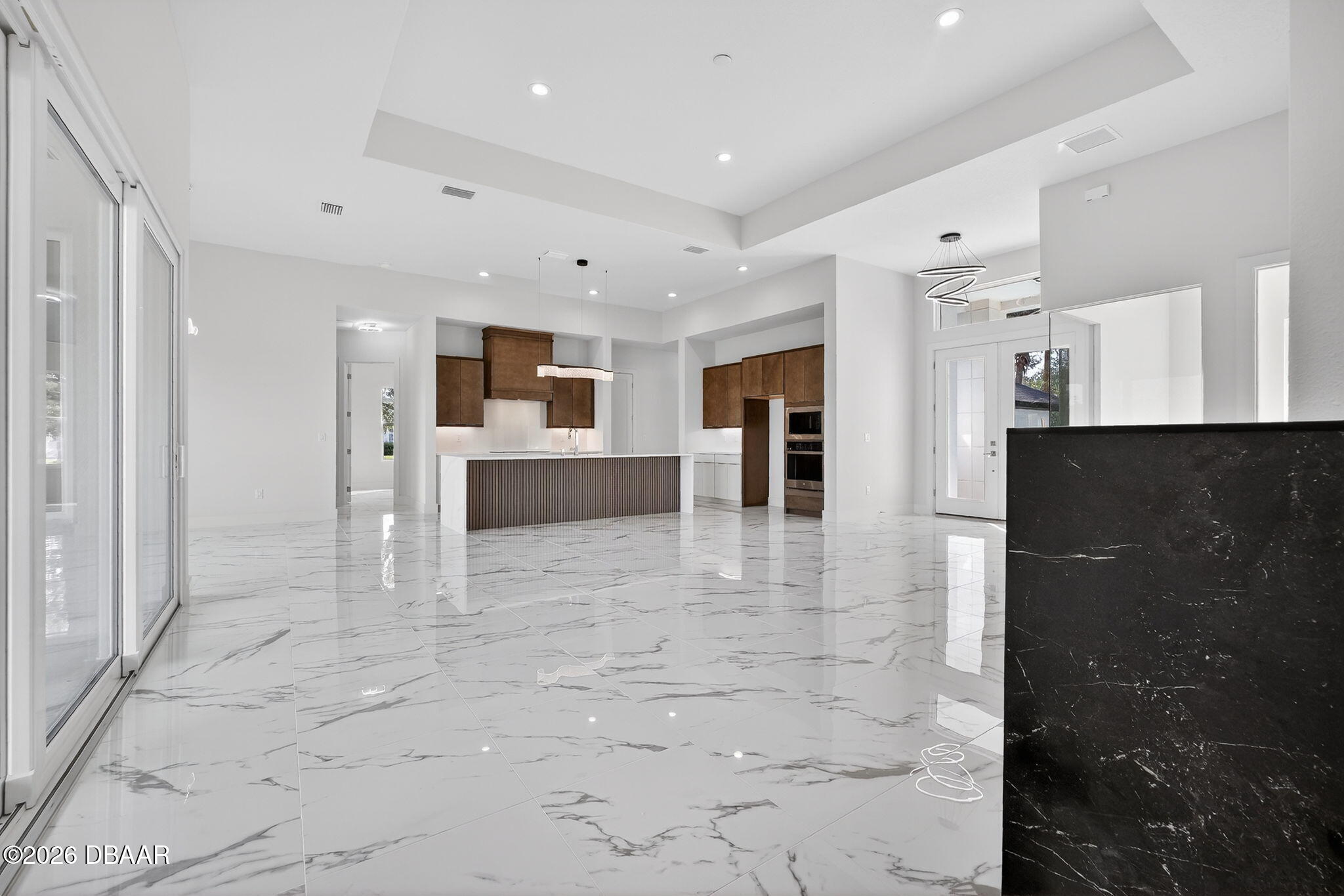 2 Huntsman Look Ormond Beach, FL 32174 - Photo 43 of 57 a view of a hallway with kitchen and stainless steel appliances