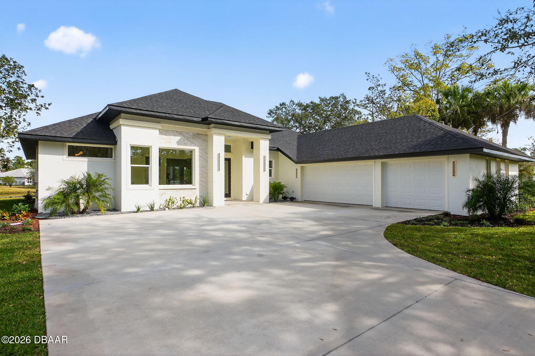 2 Huntsman Look Ormond Beach, FL 32174 - Photo 7 of 57 a front view of a house with a yard and garage