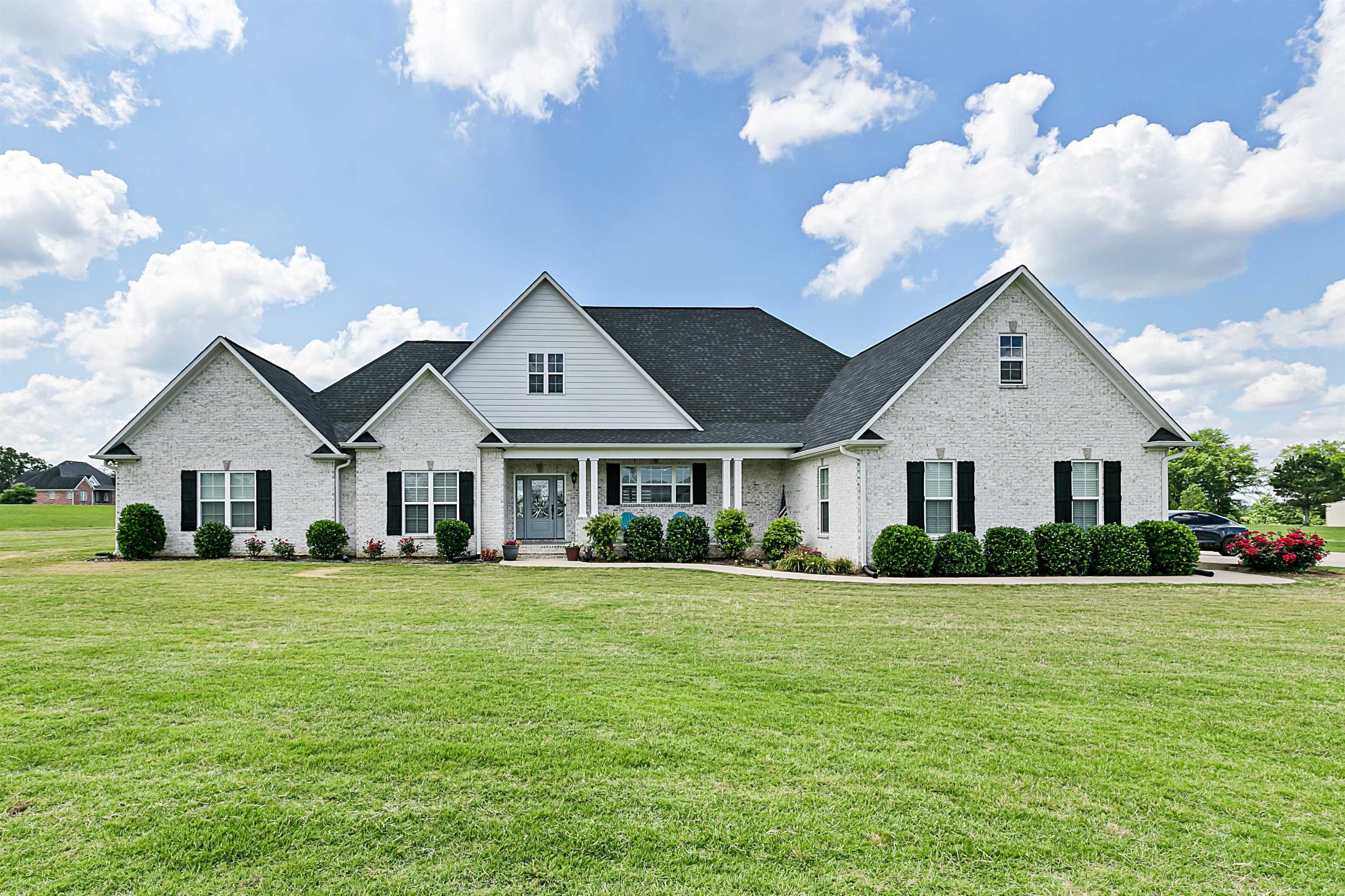 3250 Carroll Road Michie, TN 38357 - Photo 1 of 25 a front view of a house with a garden