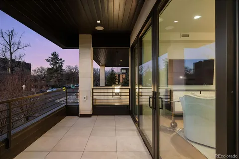 a large white bathroom with a granite countertop sink and a large mirror