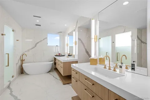 a bathroom with a tub sink and shower