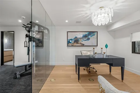 a bathroom with a sink a toilet a mirror and shower