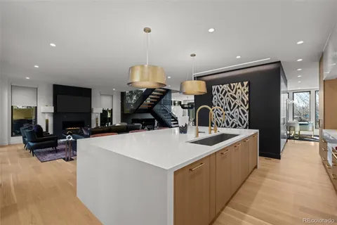 a large kitchen with kitchen island a sink a stove and a refrigerator