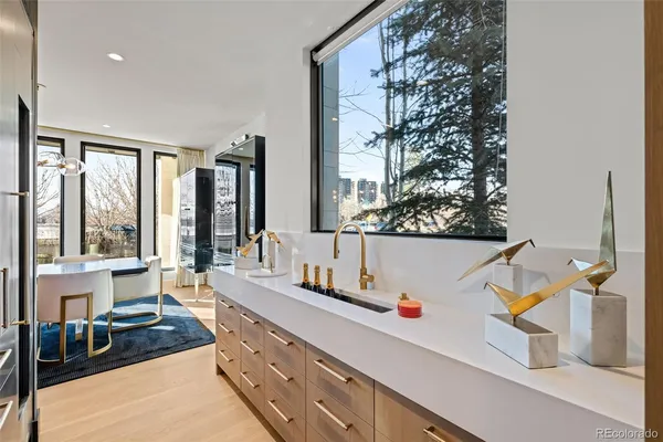a room with a large window and furniture