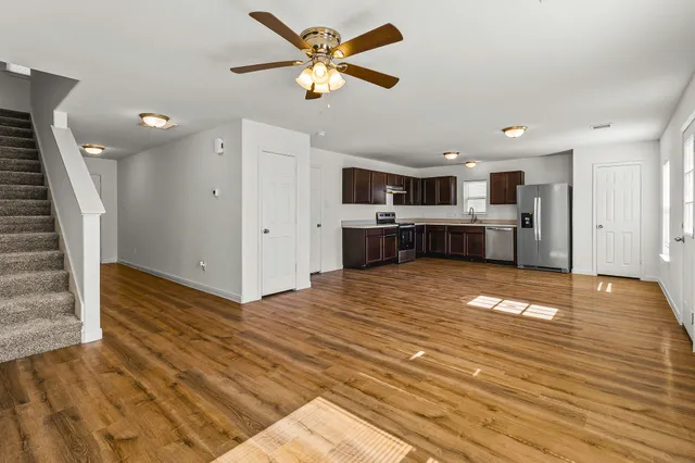 a view of a kitchen with a sink and a refrigerator