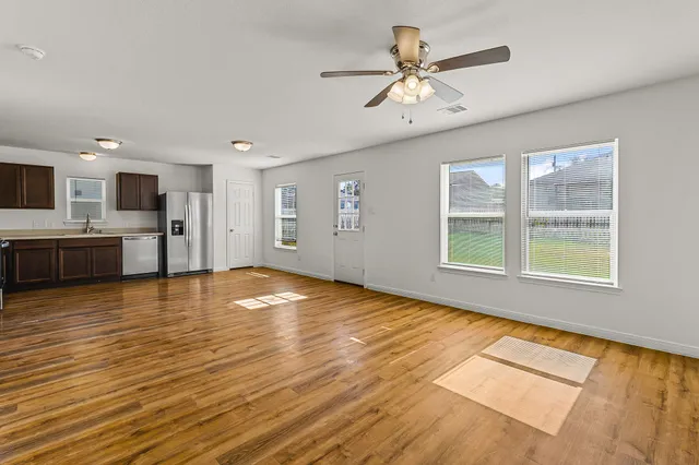 a view of a kitchen with a stove cabinets and wooden floor