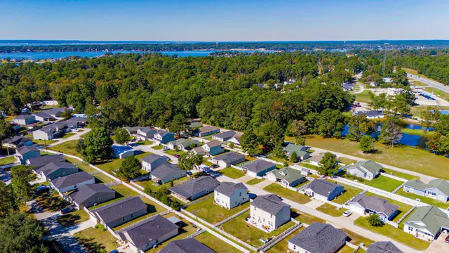 an aerial view of residential houses with outdoor space and street view