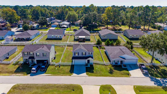 a view of multiple houses with outdoor space and swimming pool