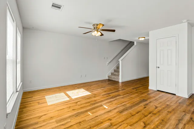 wooden floor in an empty room with a window