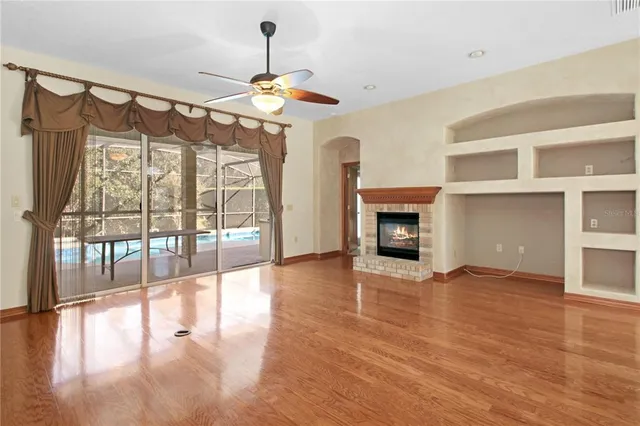a view of a room with wooden floor table and chairs