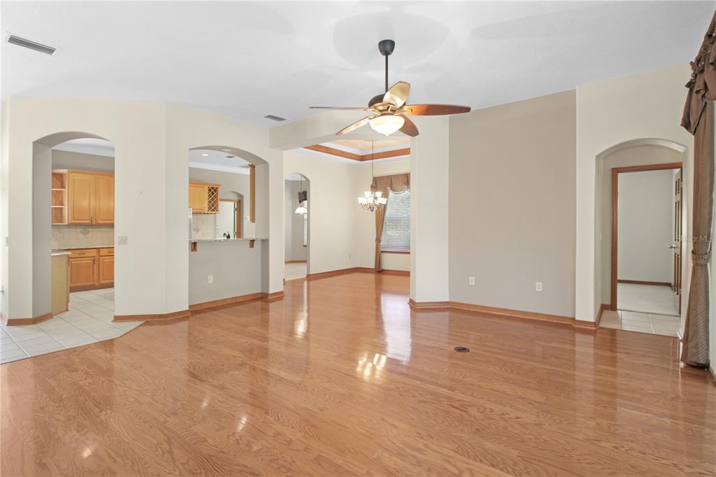400 Interlachen Court DeBary, FL 32713 - Photo 19 of 42 a view of a hallway with wooden floor and a chandelier