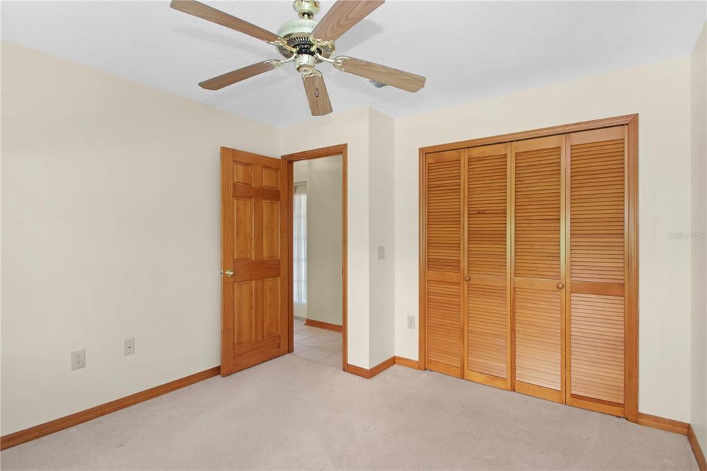 400 Interlachen Court DeBary, FL 32713 - Photo 22 of 42 an empty room with a ceiling fan