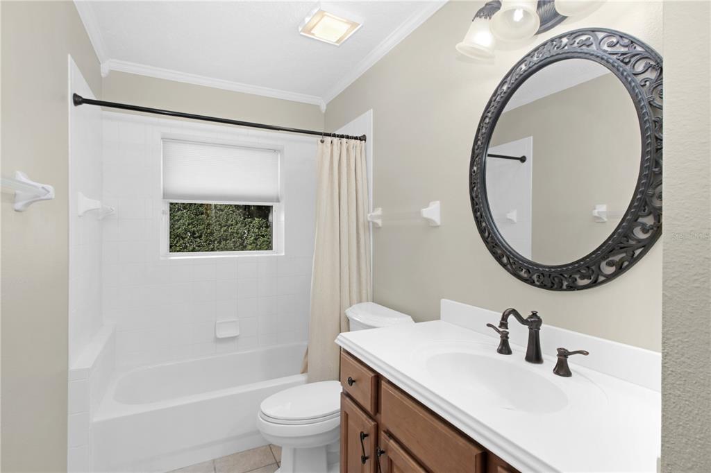 400 Interlachen Court DeBary, FL 32713 - Photo 23 of 42 a bathroom with a sink a toilet and a mirror